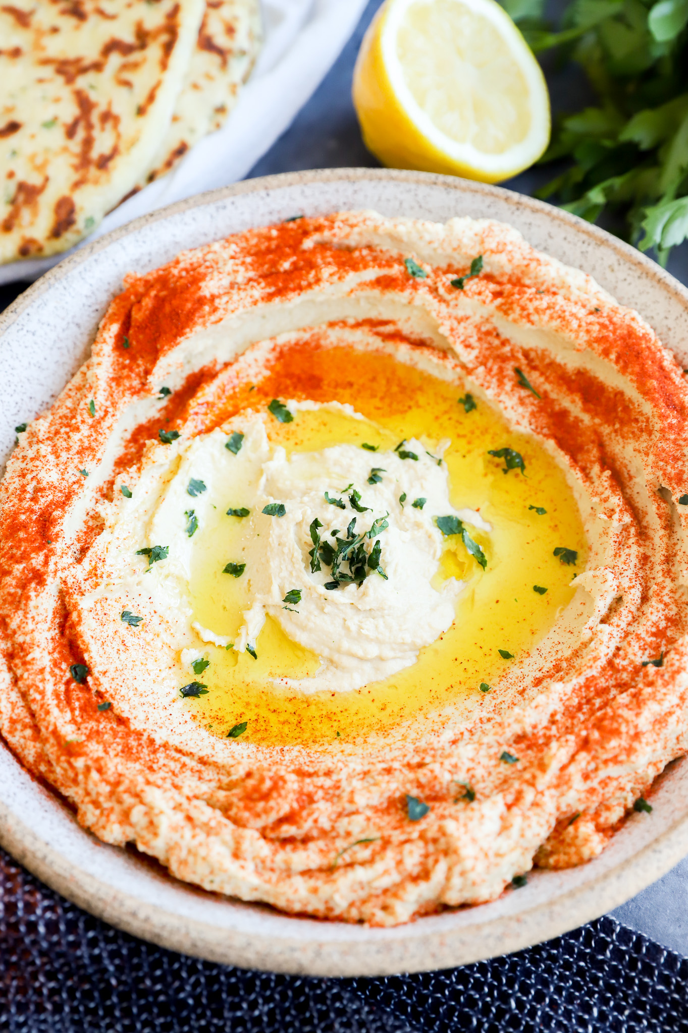 authentic chickpea creamy dip in a bowl with olive oil and sumac