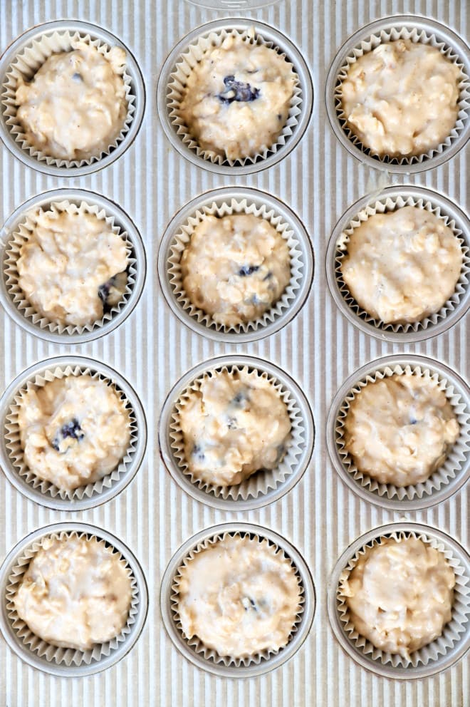 Raw muffin batter in a muffin tin