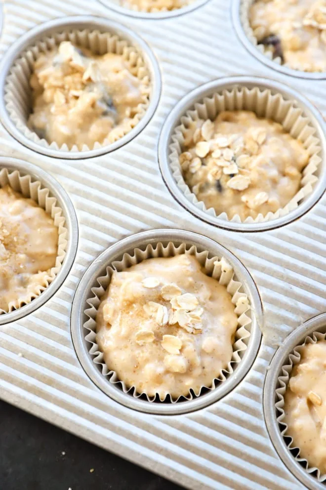 Unbaked breakfast goods with oats sprinkled on top in a pan