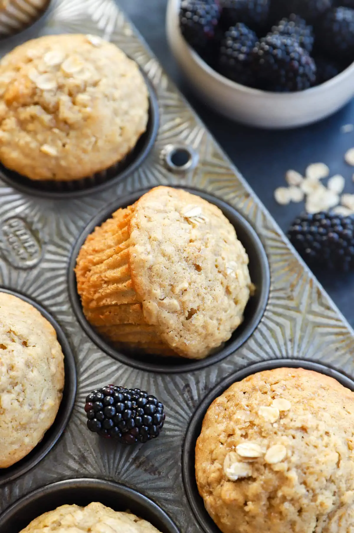 honey oatmeal blackberry muffins in baking pan