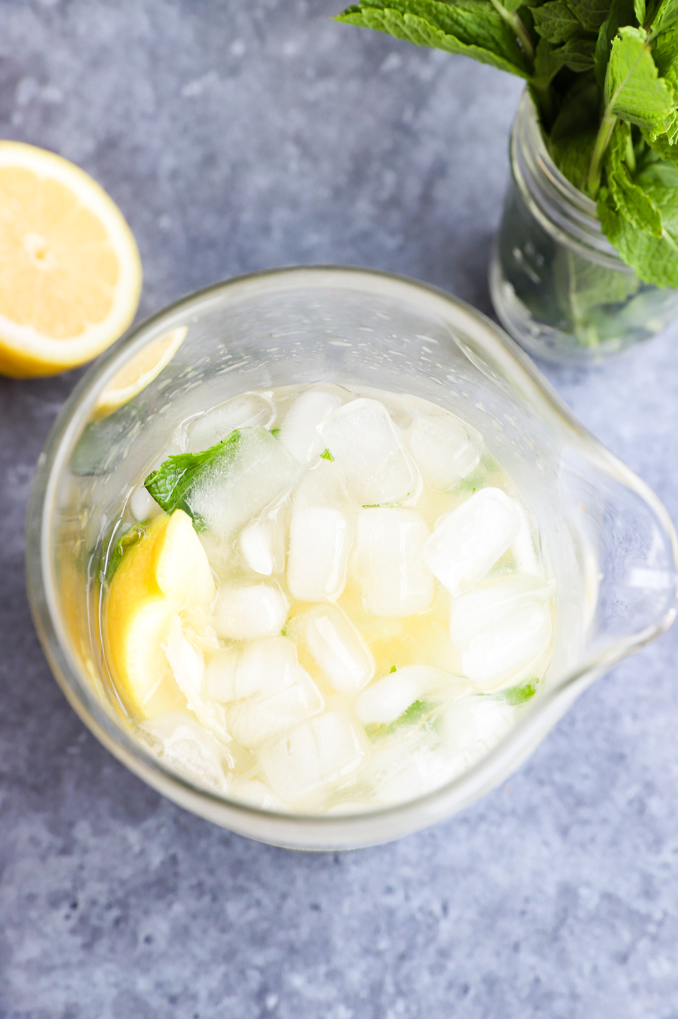 Making a citrus mint cocktail in a mixing glass photo