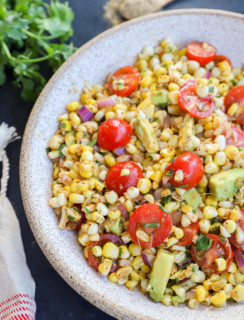 Masala corn salad in a bowl with tomatoes and avocado photo