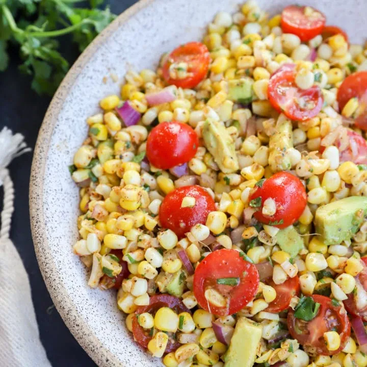 Masala corn salad in a bowl with tomatoes and avocado photo