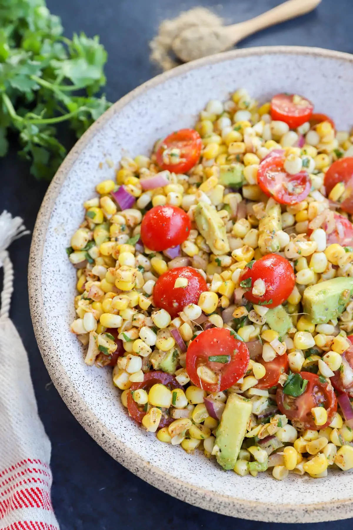 Masala corn salad in a bowl with tomatoes and avocado photo