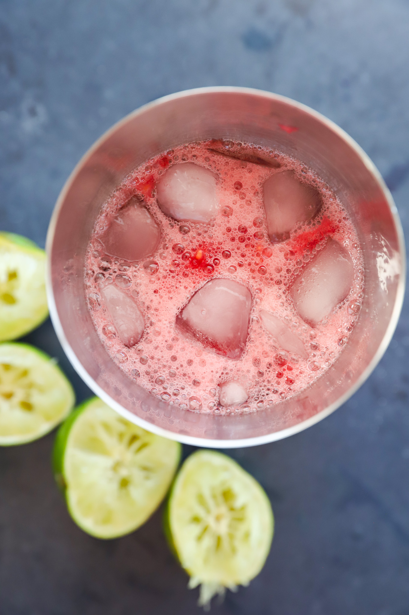 Making a raspberry daiquiri in a cocktail shaker