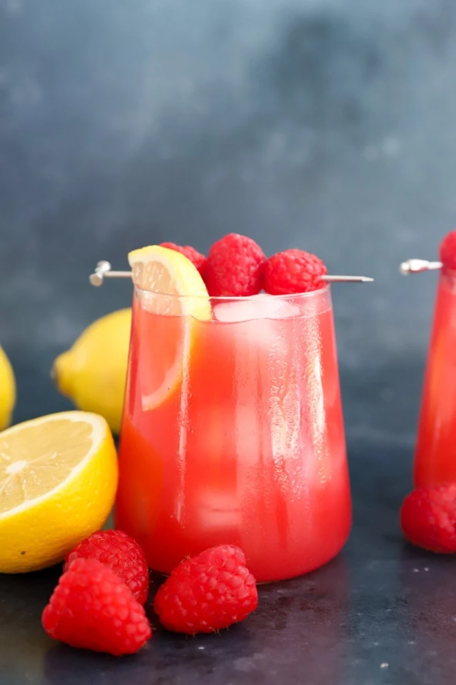 Raspberry vodka lemonade side photo in a glass with ice