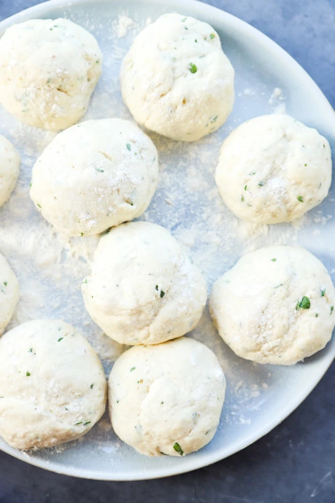 Making turkish bread into dough balls on a plate