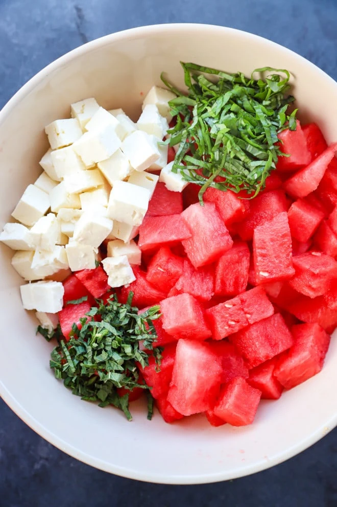 Preparing watermelon feta salad image