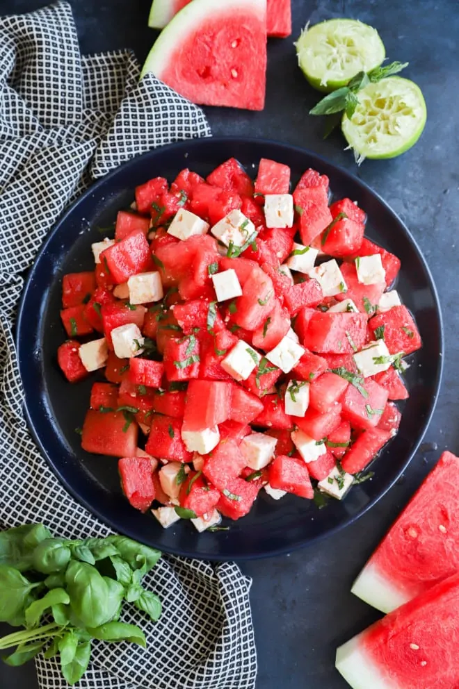 Picture of a fruit salad with cheese on a serving platter for summer