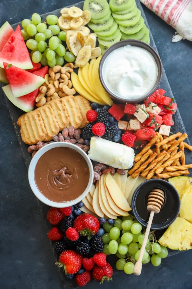 Overhead image of platter with a variety of sweets snacks and produce