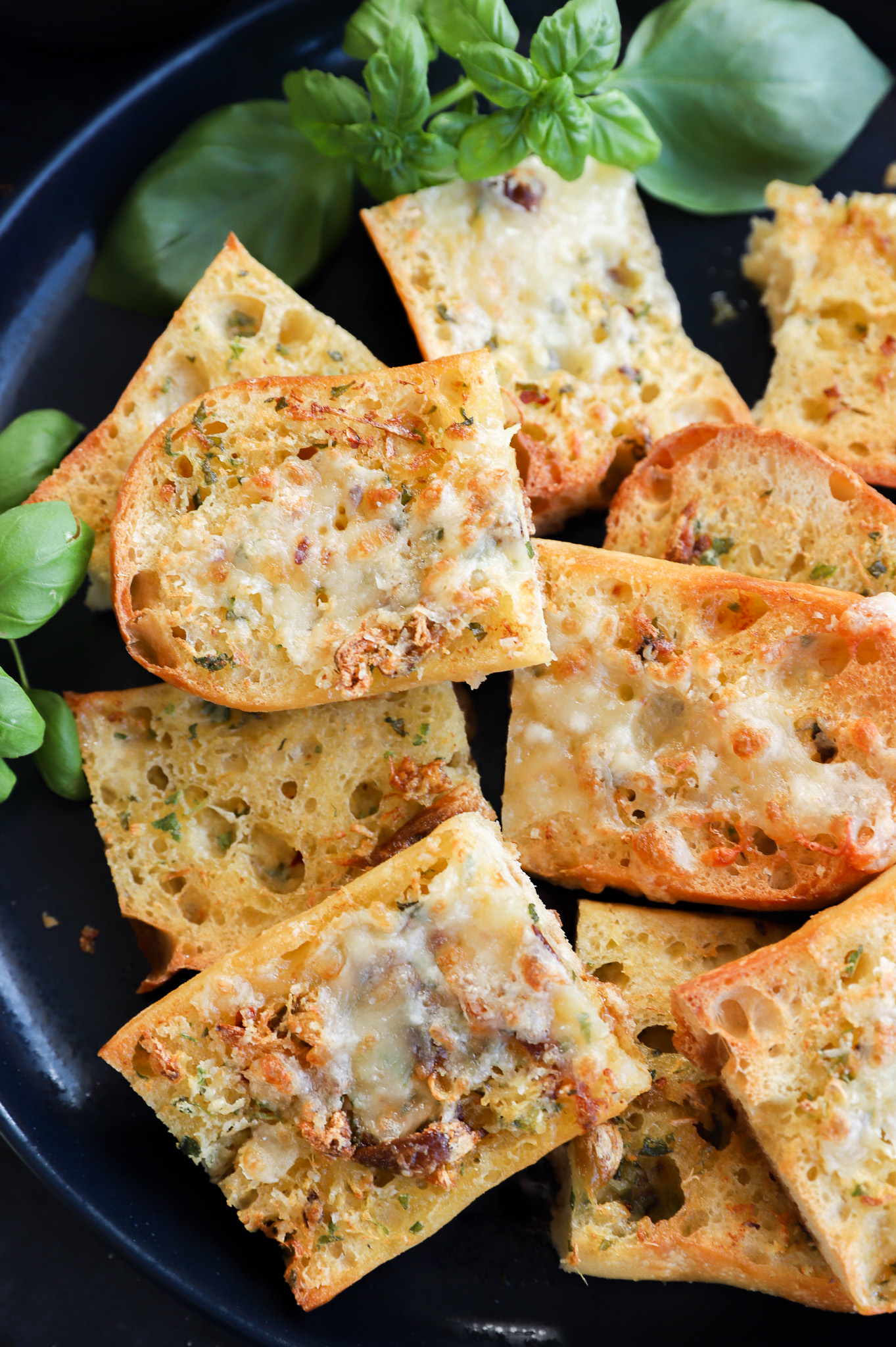 Platter of toasted slices with cheese on top