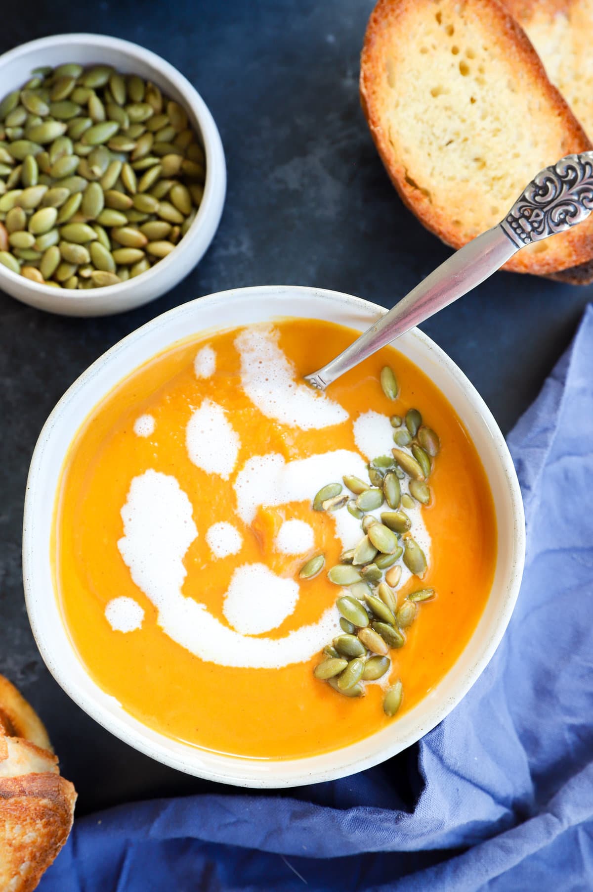 Picture of fall soup in bowl with bread and seeds