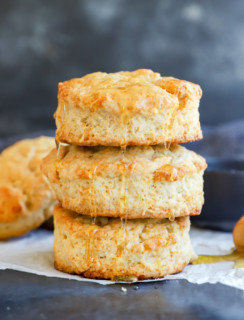 honey butter biscuits in a stack drizzled with honey