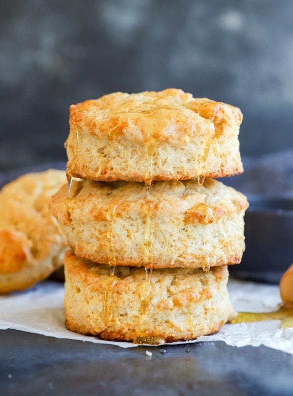 honey butter biscuits in a stack drizzled with honey