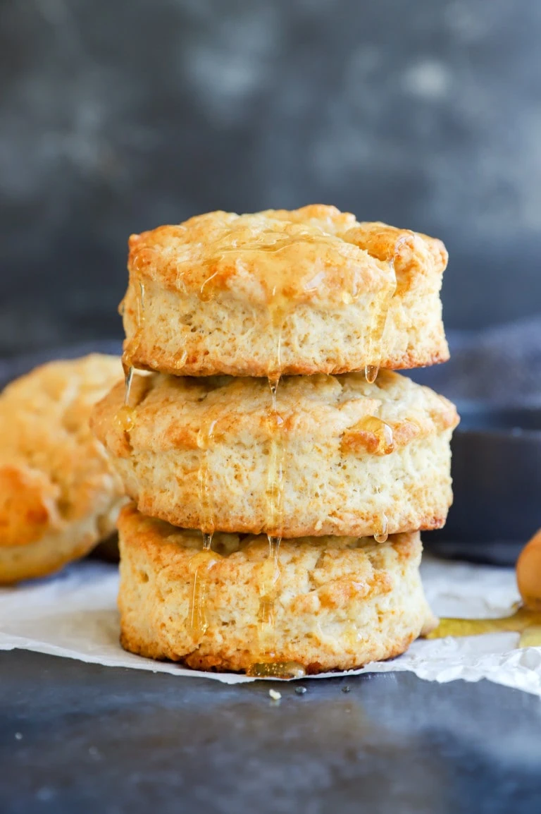 honey butter biscuits in a stack drizzled with honey