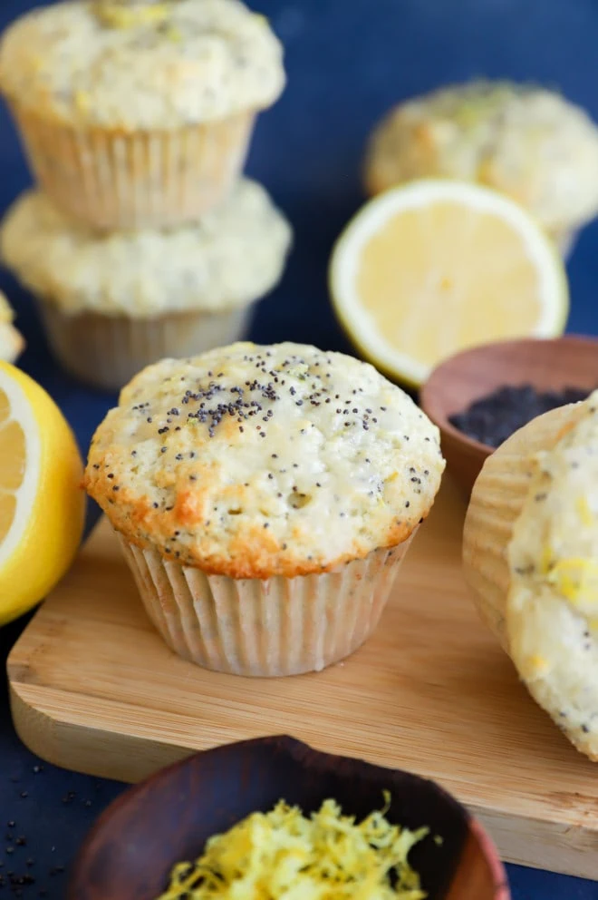 Muffins in a pile with fresh lemons and lemon zest