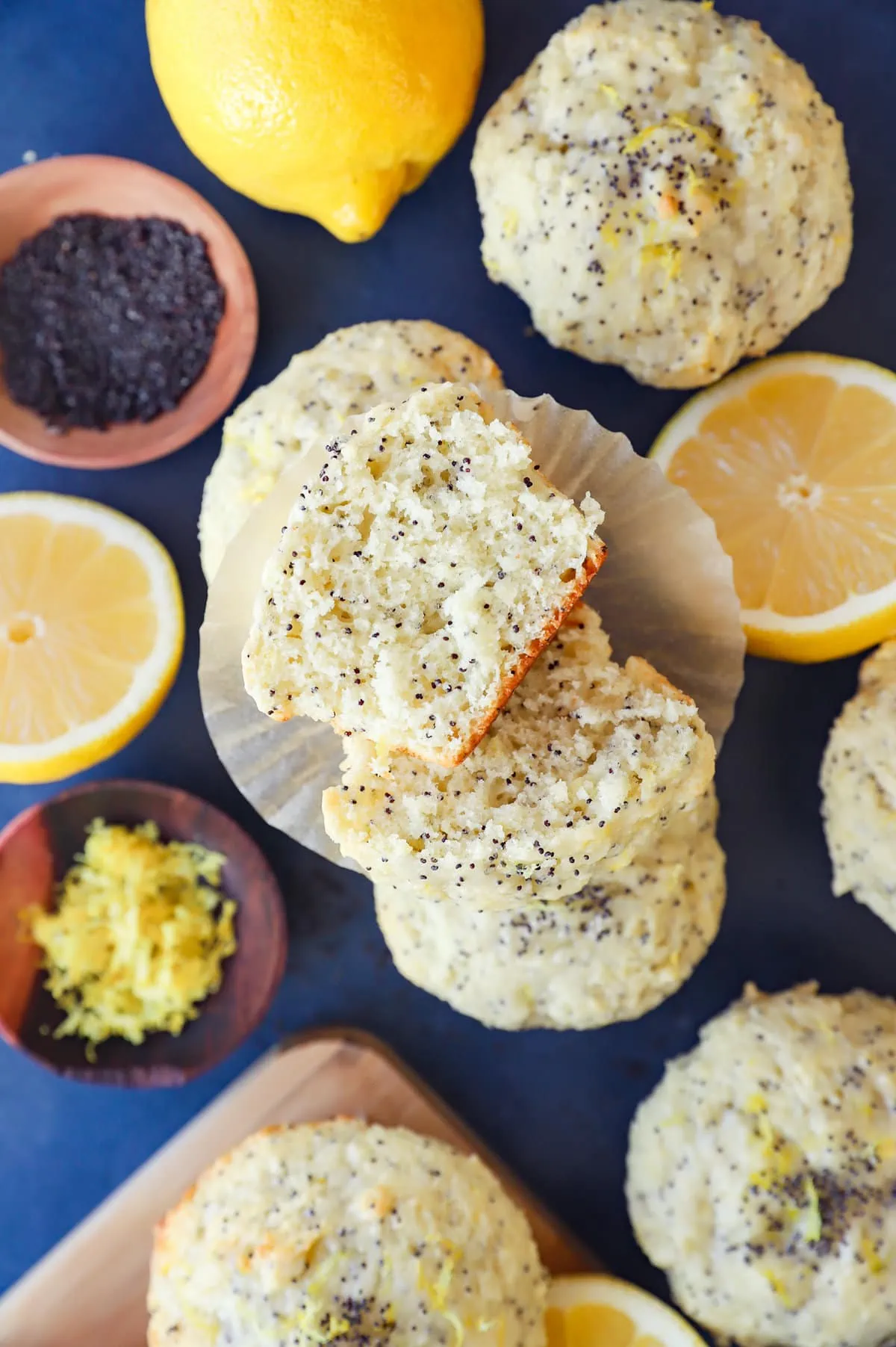 Lemon poppy seed muffins in a pile with liners