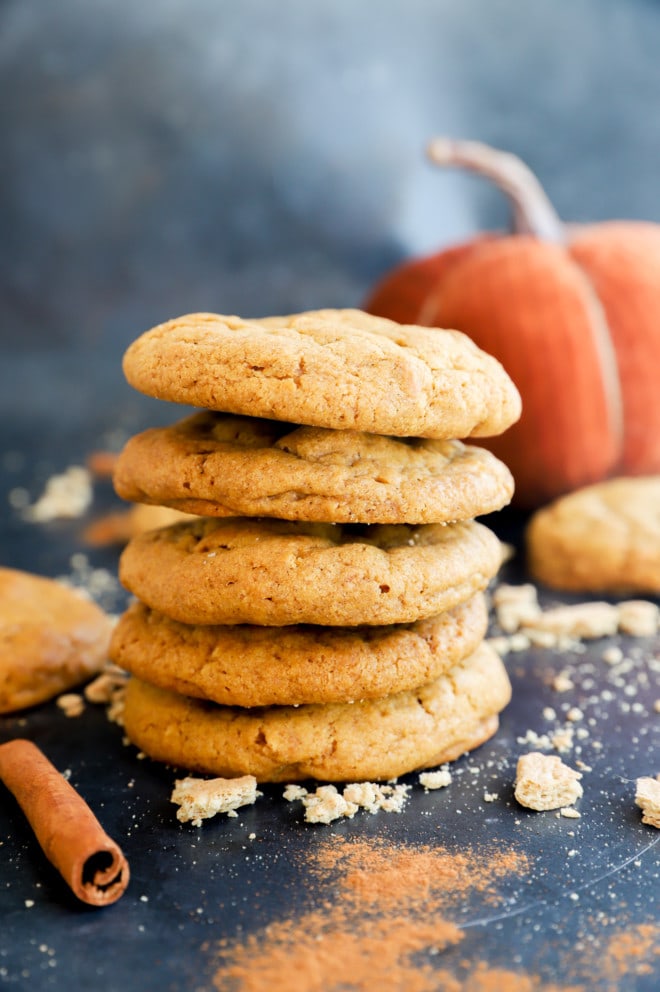 Stack of pumpkin cheesecake cookies with cinnamon sticks