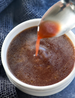 spooning au jus into a bowl