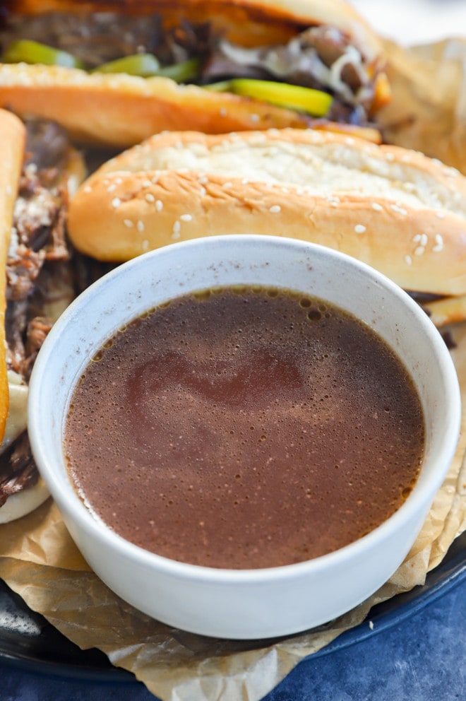 au jus sauce recipe with French dip sandwiches on a plate