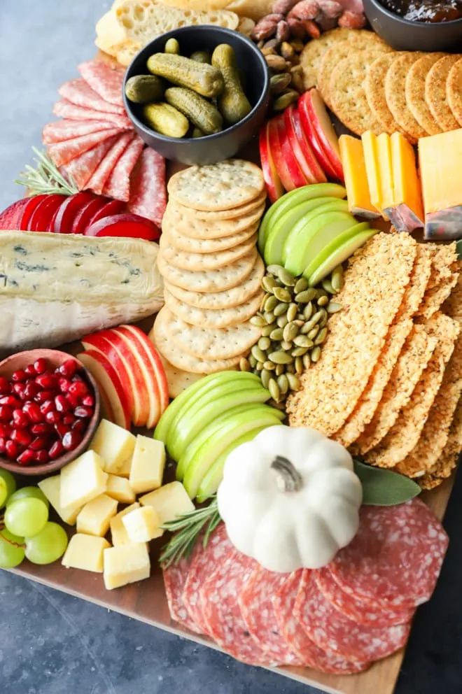 autumn ingredients on cutting board with fruits and crackers