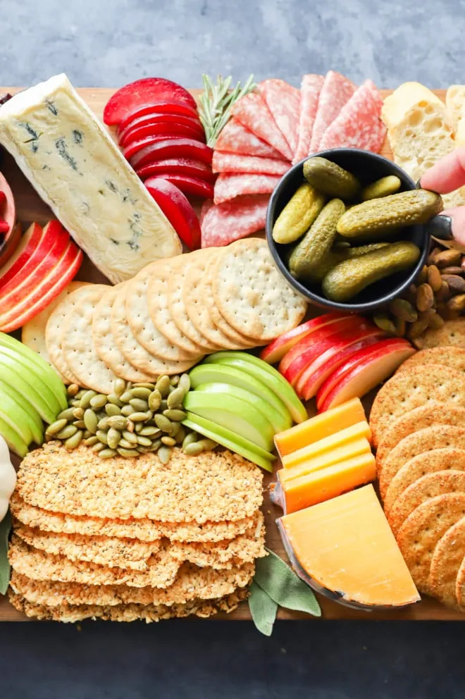 Cheeses and meats and crackers on a board image