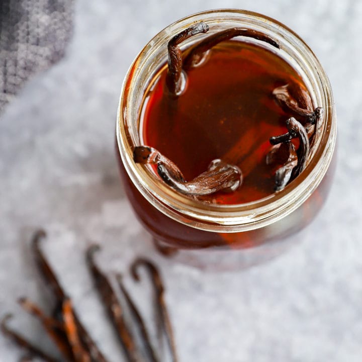 making homemade vanilla extract in a mason jar with whole vanilla beans