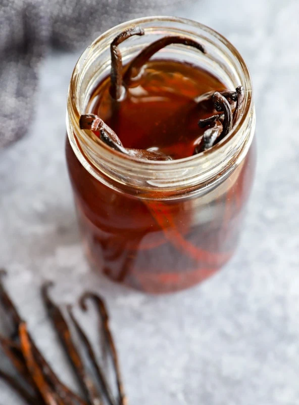 Jar of homemade vanilla extract with beans in it
