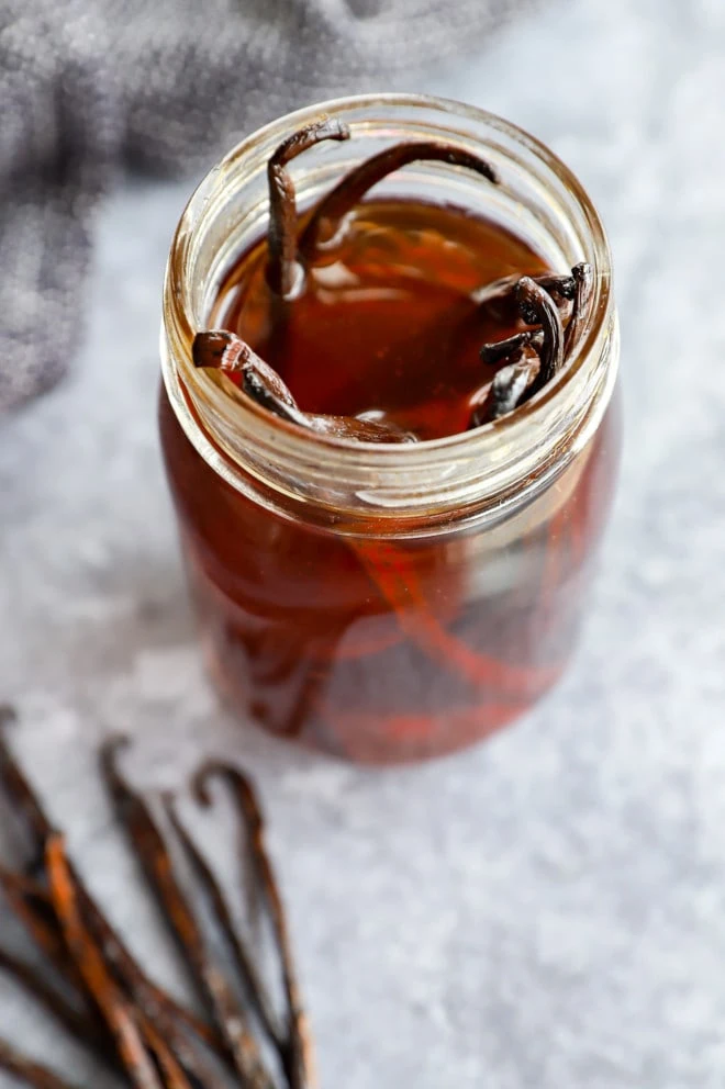 Jar of homemade vanilla extract with beans in it