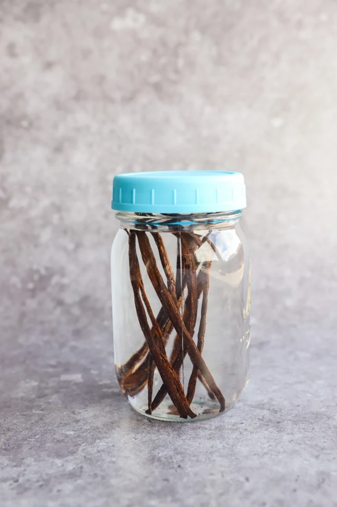 vanilla beans in a jar with vodka sealed