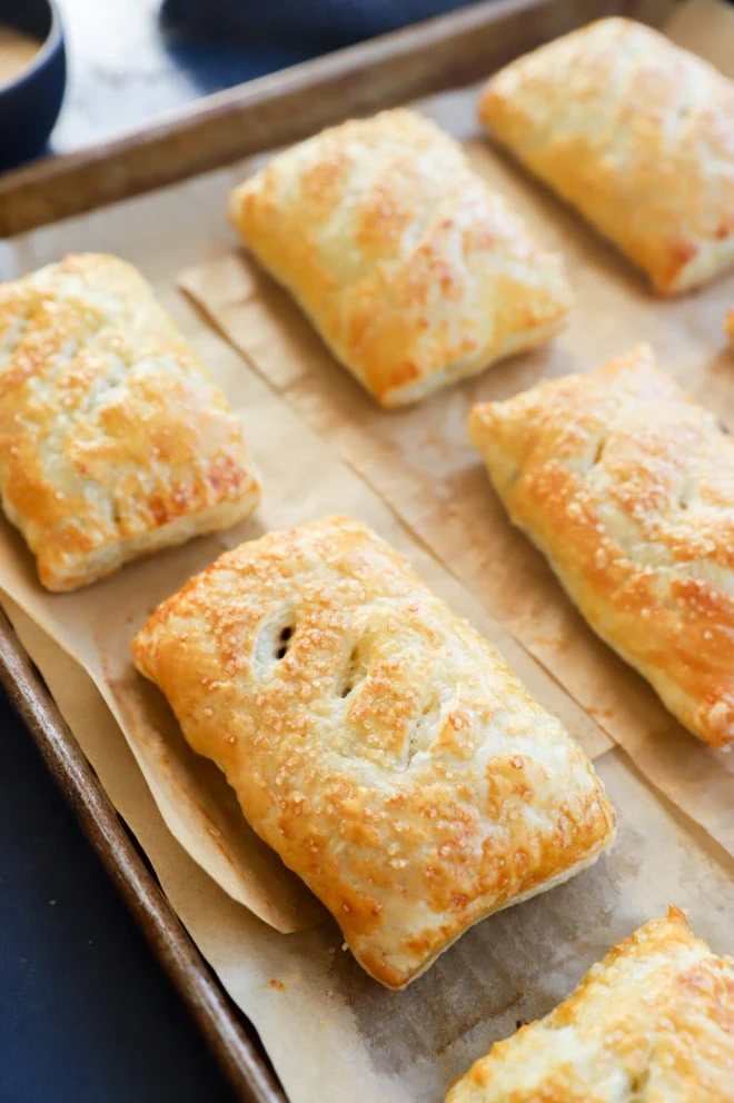 Nutella puff pastry pies on baking sheet with parchment paper