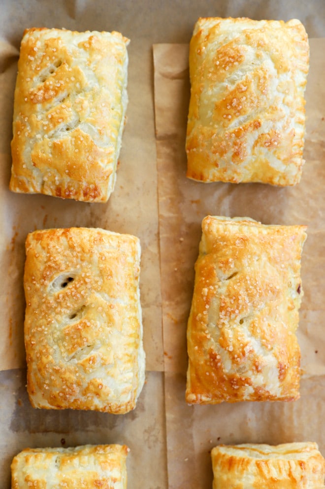 Photo of sweet baked treats on baking sheet with parchment paper