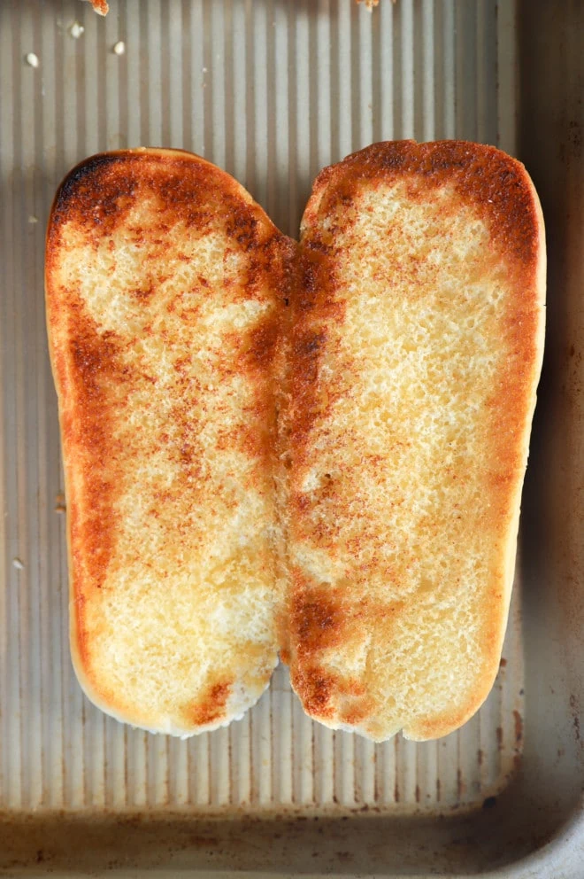 bun toasted with garlic butter on sheet pan