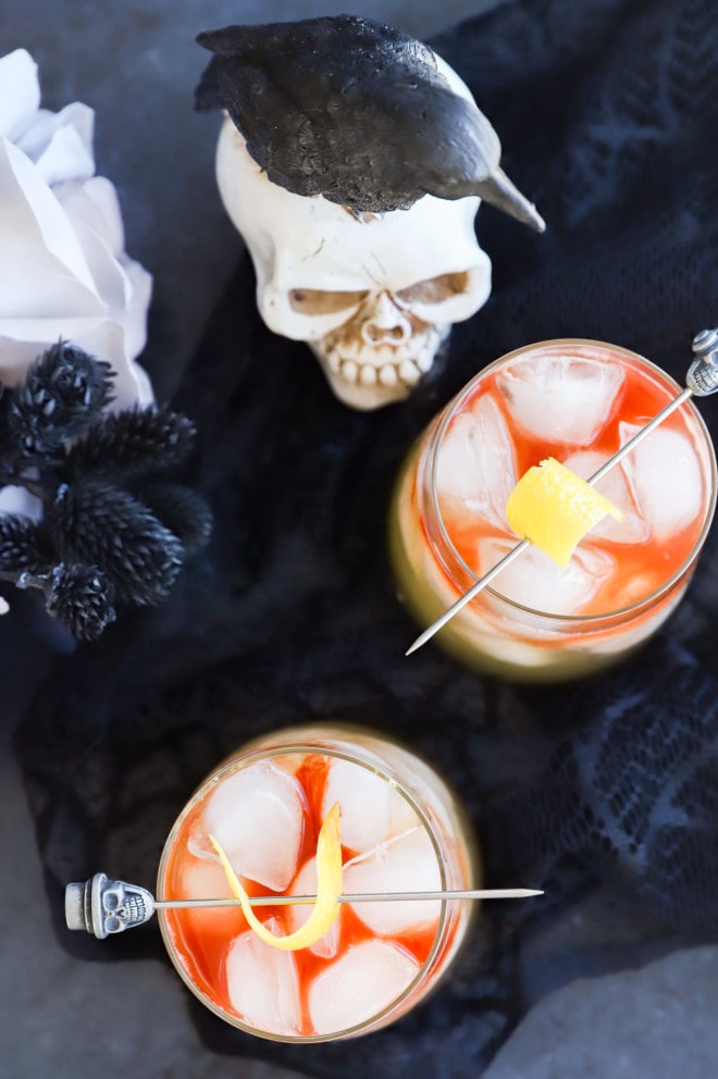 halloween cocktails in glasses with skull toothpicks