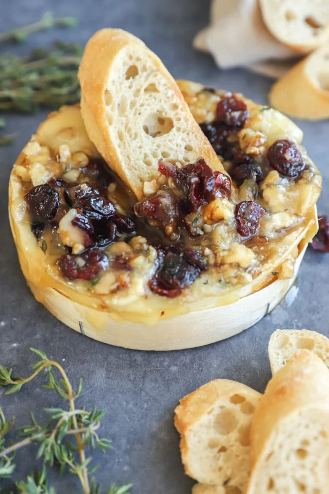 Easy baked camembert with piece of toasted piece of bread stuck in the middle