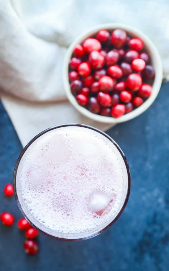 Cranberry margarita in a cocktail shaker with ice