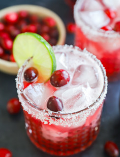 Photo of cocktail garnished with lime and fresh cranberries