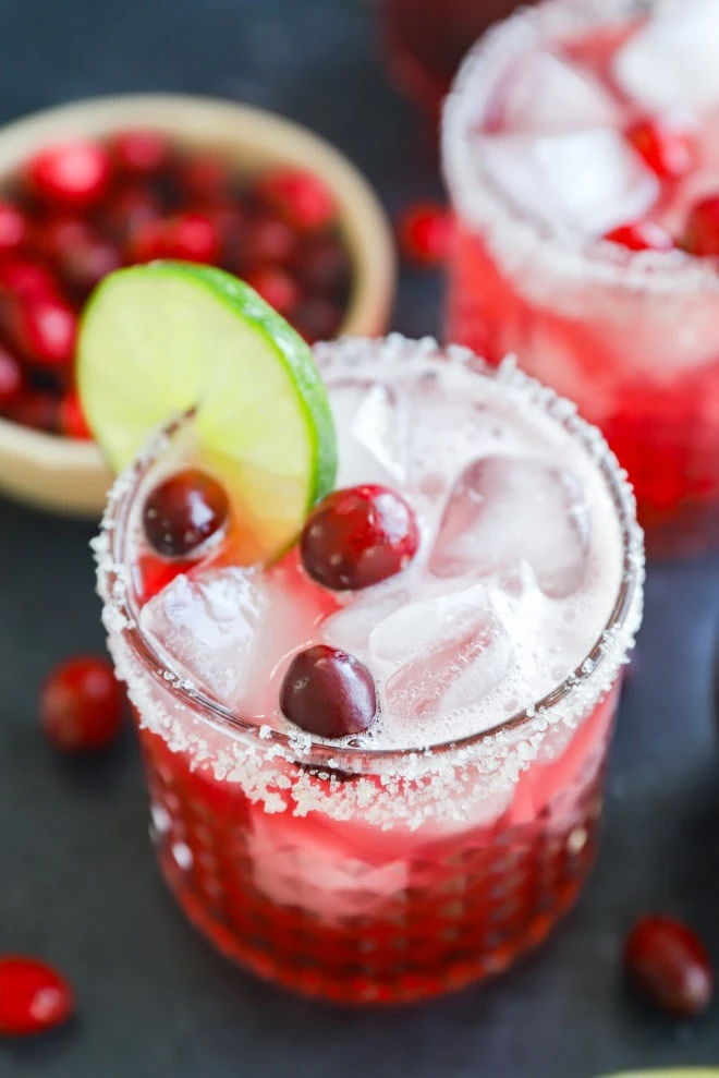 Photo of cocktail garnished with lime and fresh cranberries