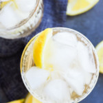 gin and ginger ale in glasses with lemon wedges and bar spoon