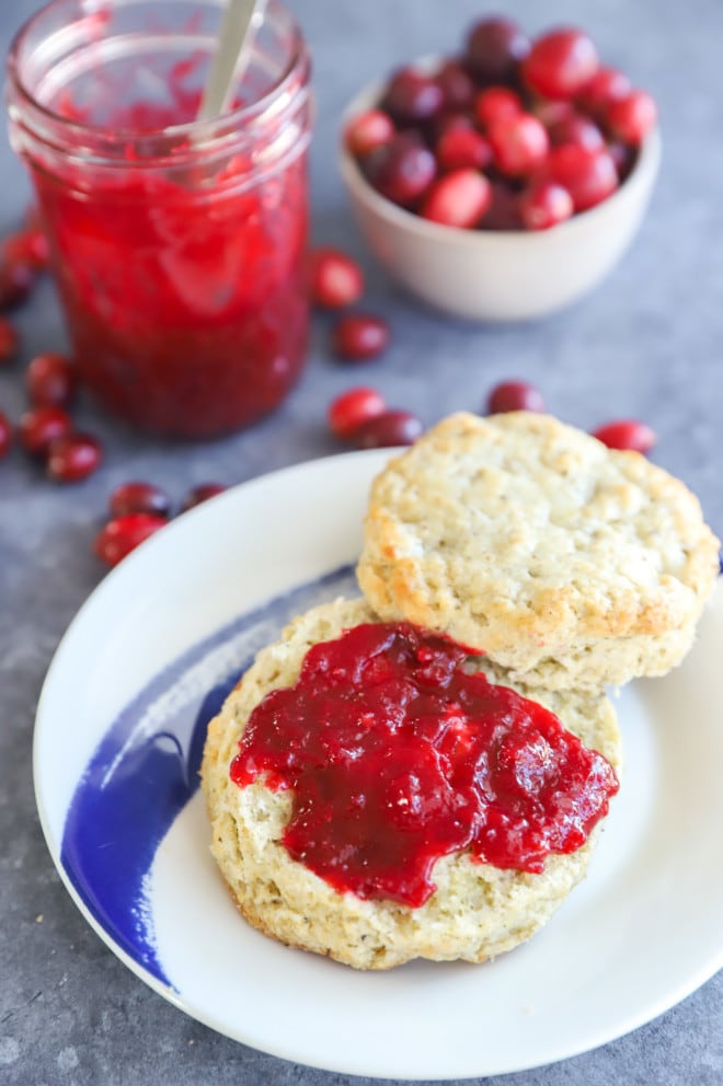 cranberry jam spread on a biscuit on a plate