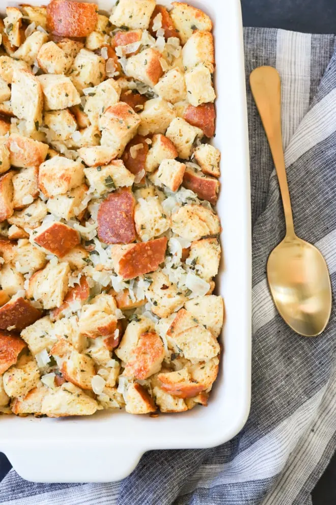 Cooked sage and onion stuffing in casserole dish with spoon