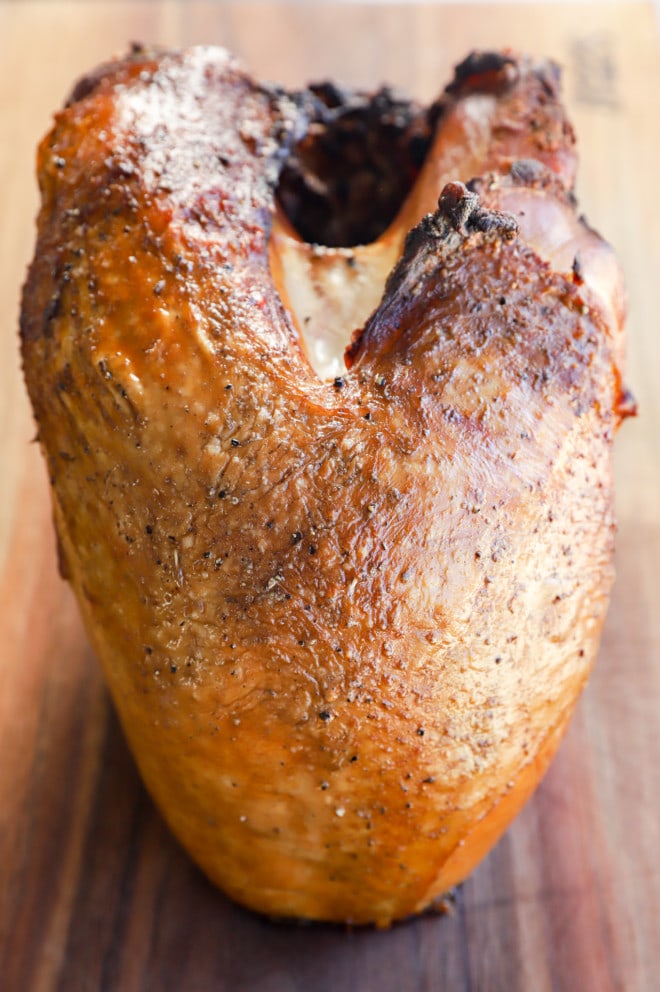 Smoked turkey breast on cutting board before slicing