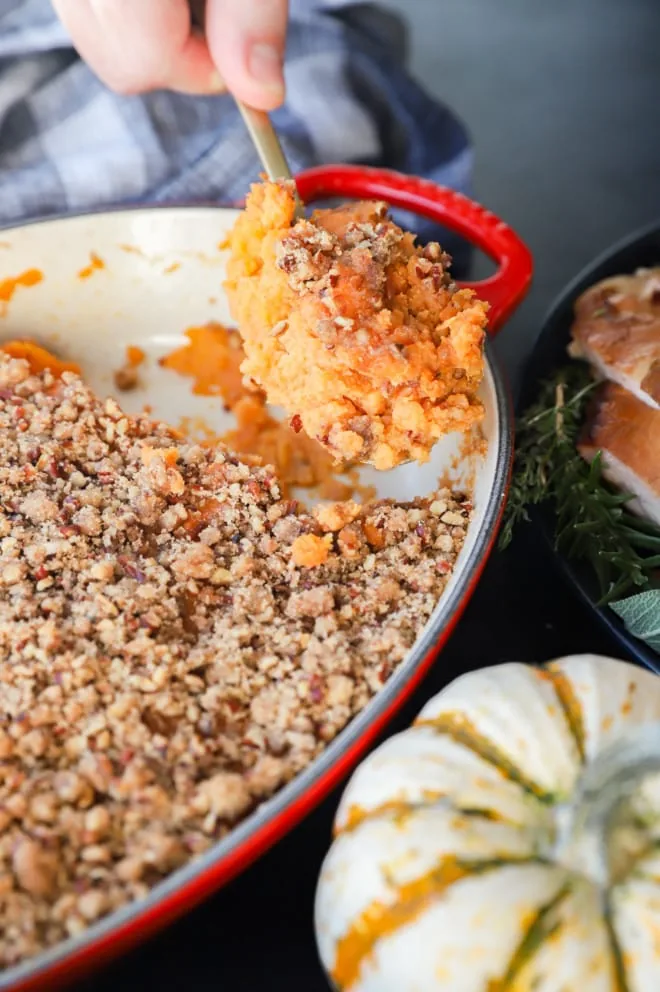 Spooning out side dish on Thanksgiving table