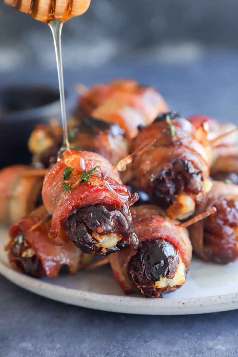 Drizzling honey over the bacon wrapped dates