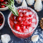 Glass of a holiday cocktail with festive decorations