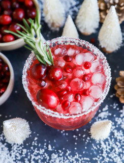 Glass of a holiday cocktail with festive decorations