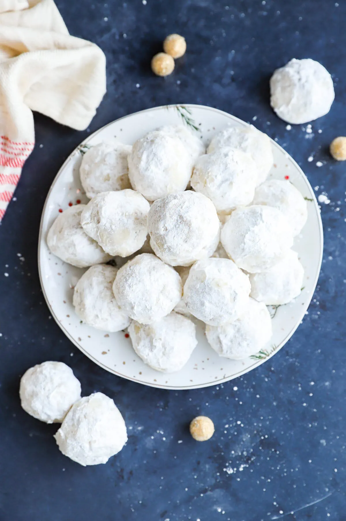 christmas treats with powdered sugar on a plate in a pile