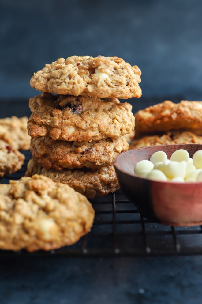 stack of cookies on a wire rack with white chocolate chips