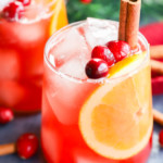 Glasses full of christmas punch with cinnamon sticks in them