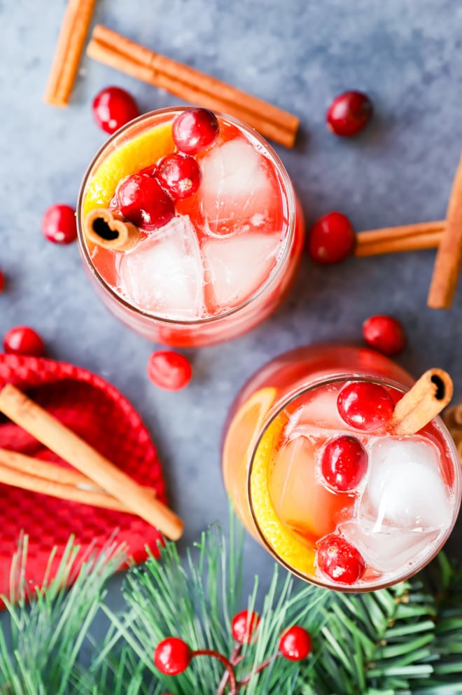 Image of holiday cocktail with cranberries oranges and cinnamon sticks